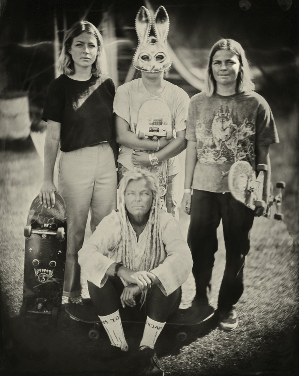Portrait of a group of people with skateboards