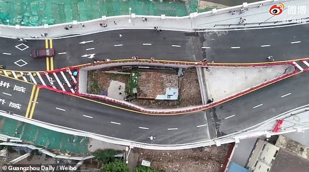 Chinese city builds a motorway bridge around a house after its ...